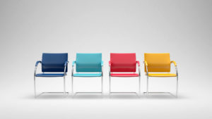 Four coloured chairs in empty space