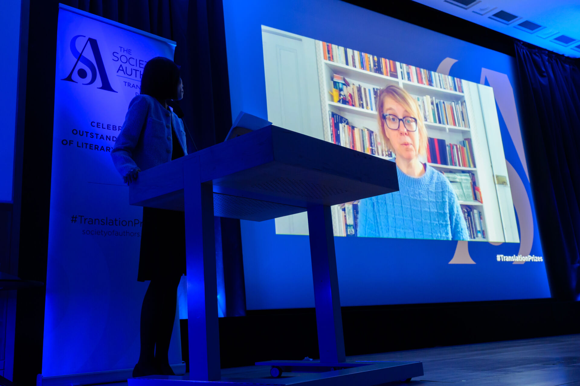 Agnes Broomé on a large screen on the stage