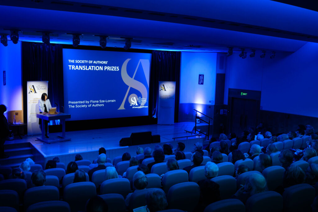 Host Fiona Sze-Lorrain from the back of the auditorium addressing the audience