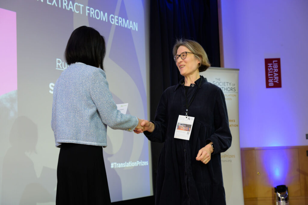 Sarah Escritt shaking hands with Fiona Tse-Lorrain