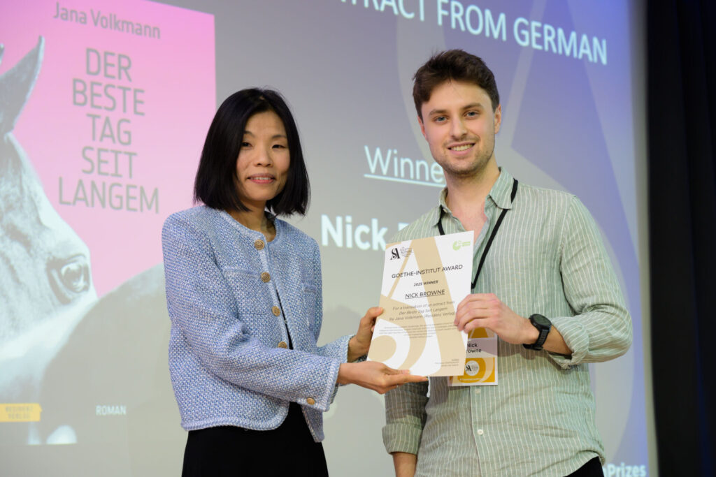 Nick Browne holding a certificate with host Fiona Sze-Lorrain