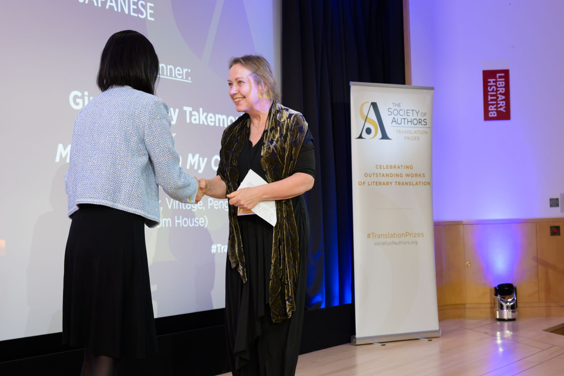 Ginny Tapley Takemori receiving her certificate from Fiona Tse-Lorrain