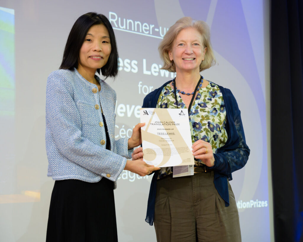 Tess Lewis holding a certificate with host Fiona Sze-Lorrain