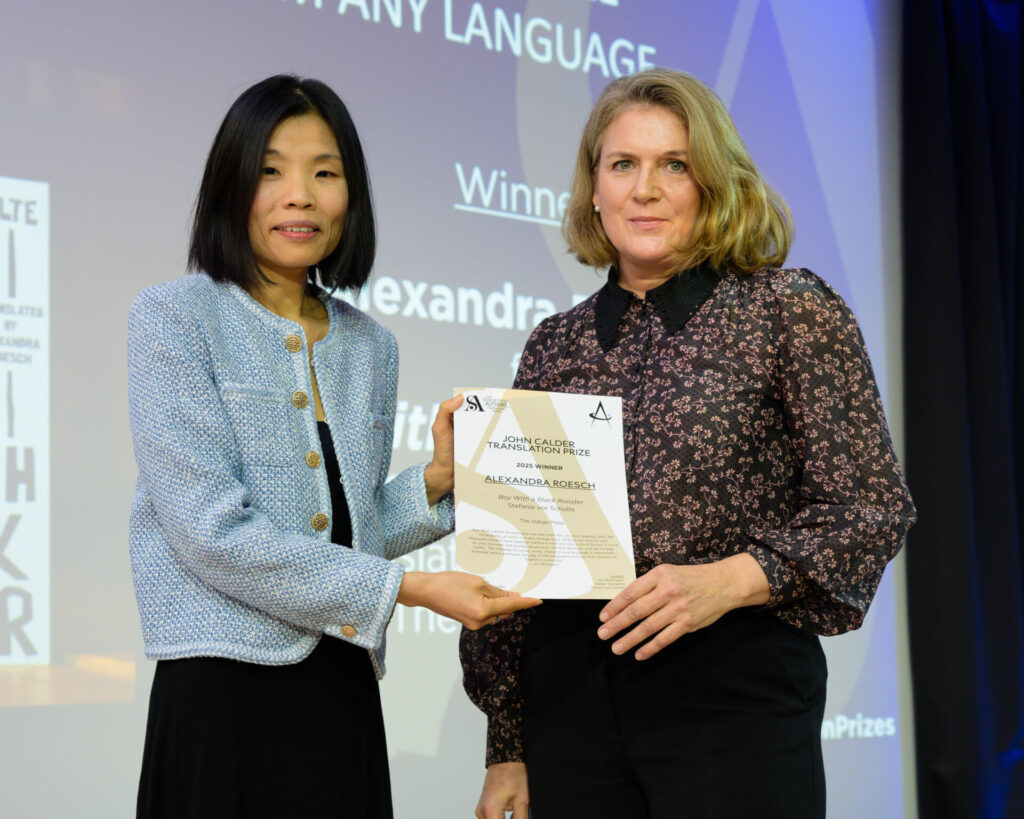 Alexandra Roesch holding a certificate with host Fiona Sze-Lorrain