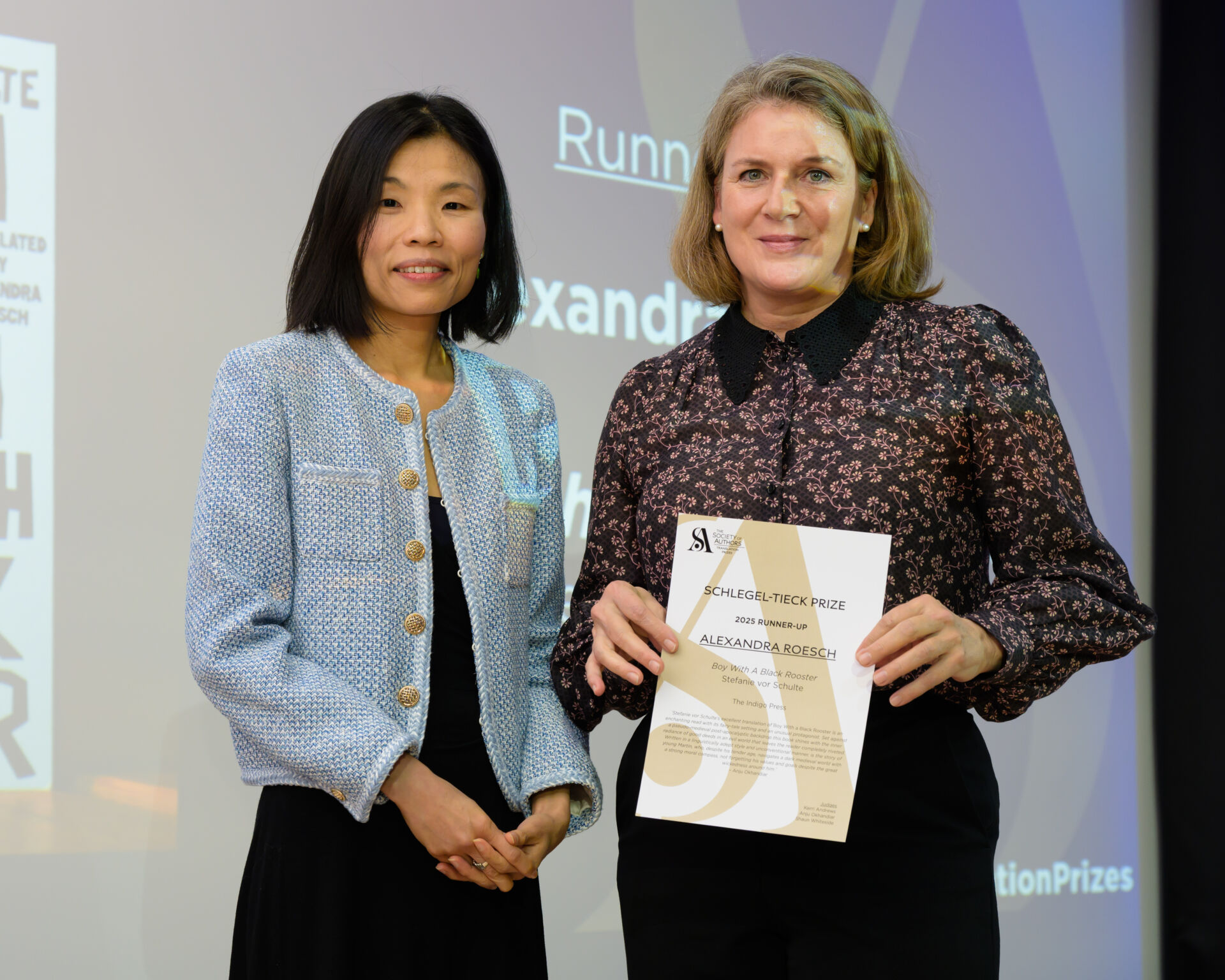 Alexandra Roesch holding a certificate with host Fiona Sze-Lorrain