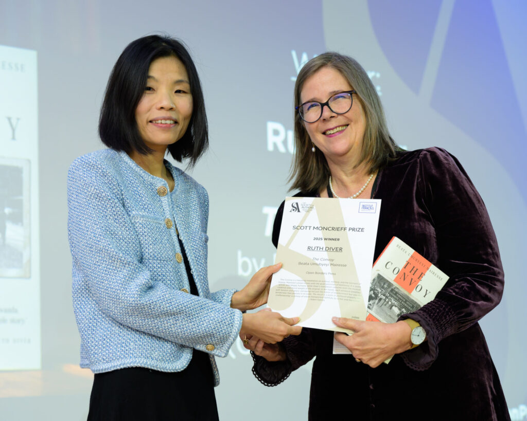 Ruth Diver holding a certificate with host Fiona Sze-Lorrain