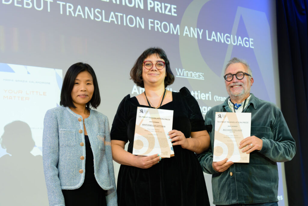 Antonella Lettieri and Richard Village holding certificates with host Fiona Sze-Lorrain