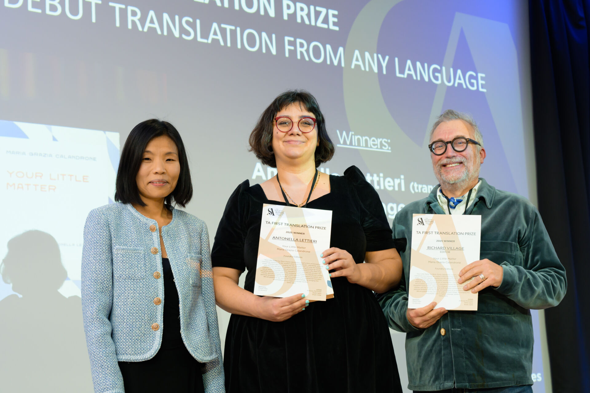 Antonella Lettieri and Richard Village holding certificates with host Fiona Sze-Lorrain