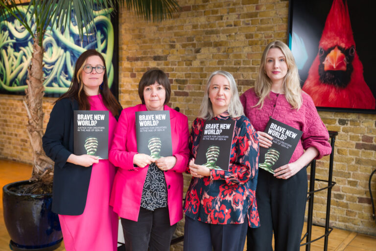 Four women standing in a group and holding copies of the Brave New World? report