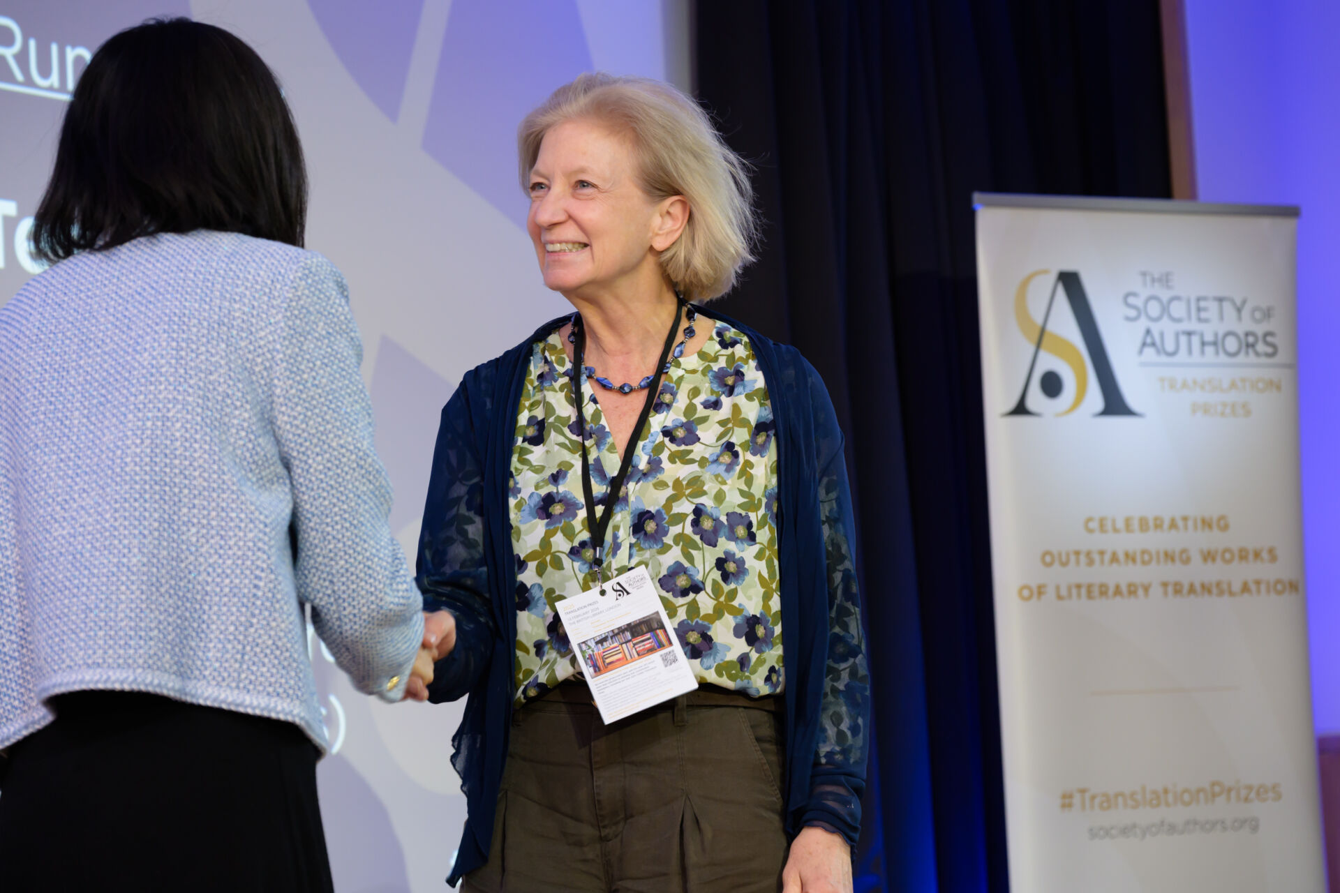 Tess Lewis shaking Fiona Sze-Lorrain's hand