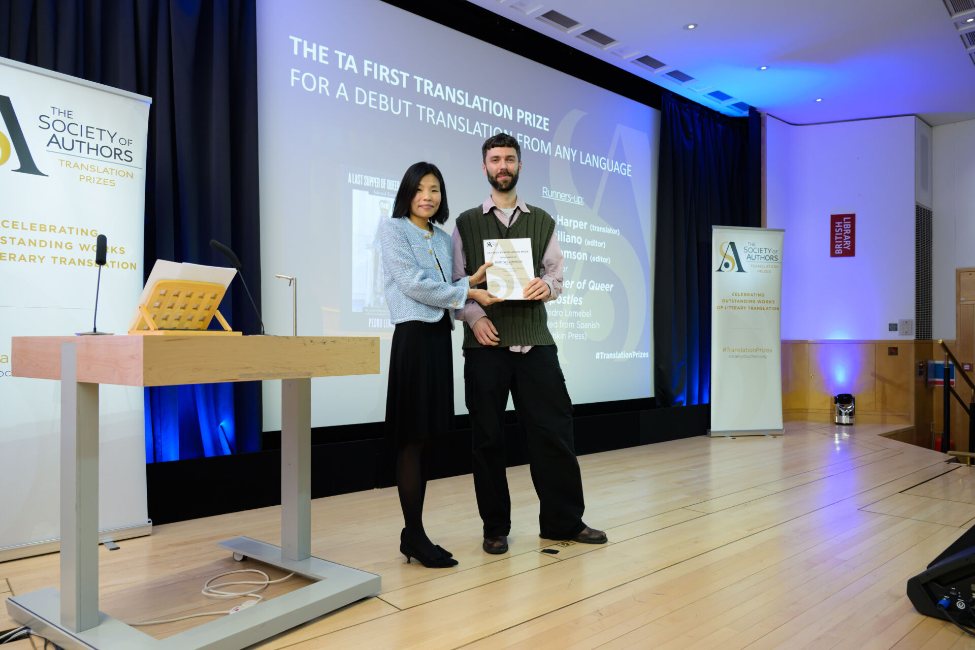 Rory Williamson holding a certificate with Fiona Sze-Lorrain