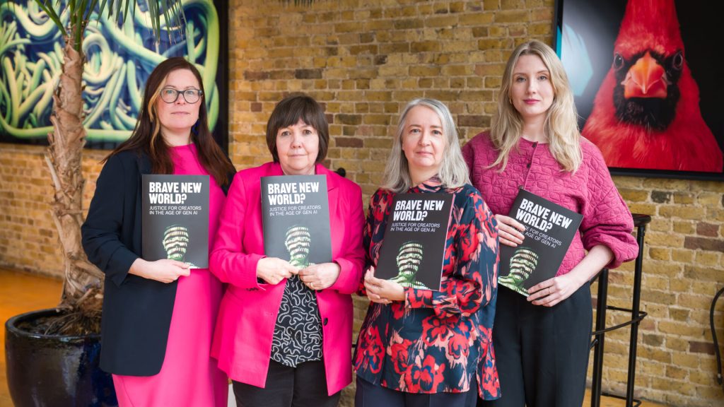 Four women standing in a group and holding copies of the Brave New World? report