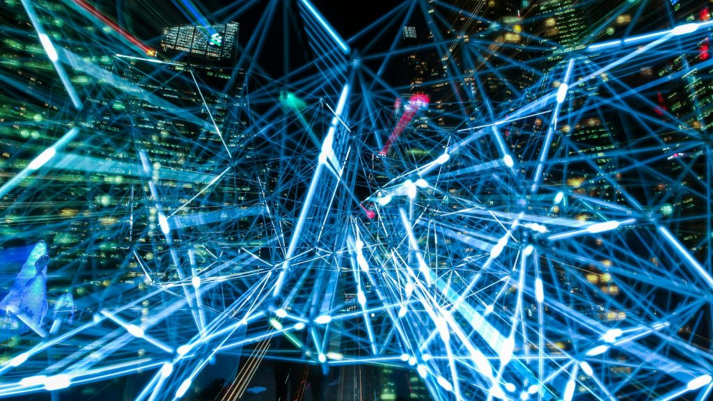 Dynamic urban scene showcasing interconnected light trails representing digital communication networks.